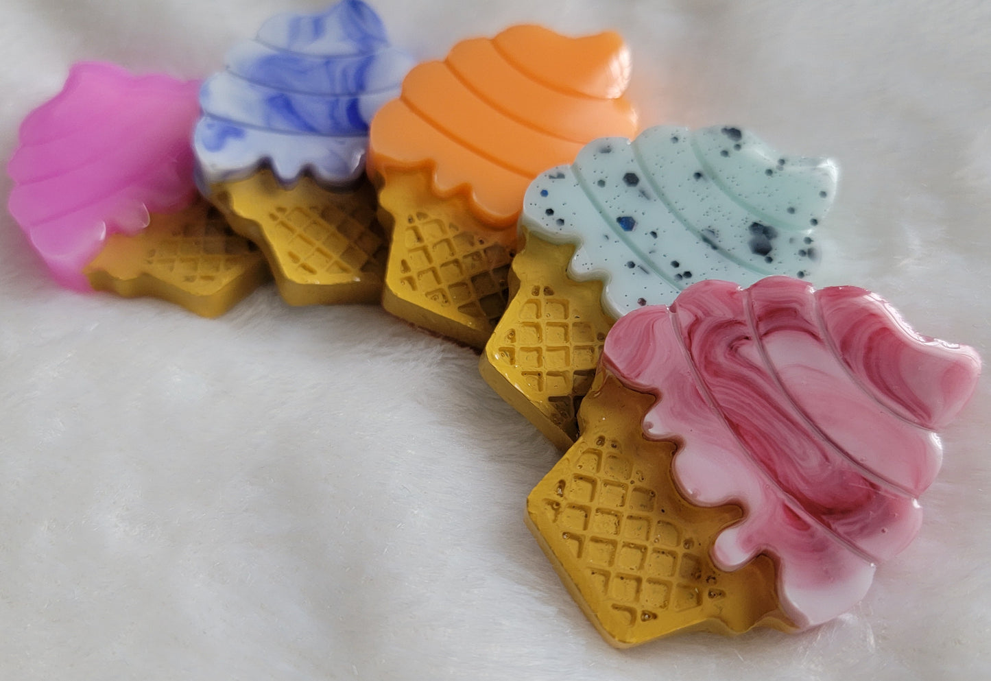 Five ice cream cone shaped epoxy resin pieces, colors shown are bright pink, blue and white swirl, deep red and white swirl, bright orange, and light green with black glitter.