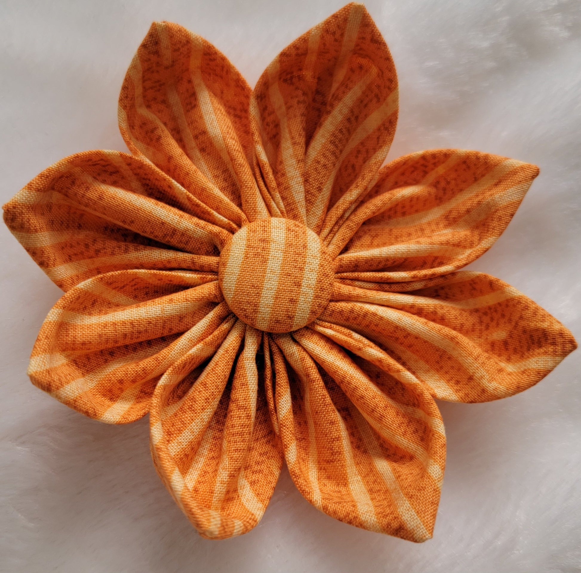 Warm golden tan striped fabric flower.