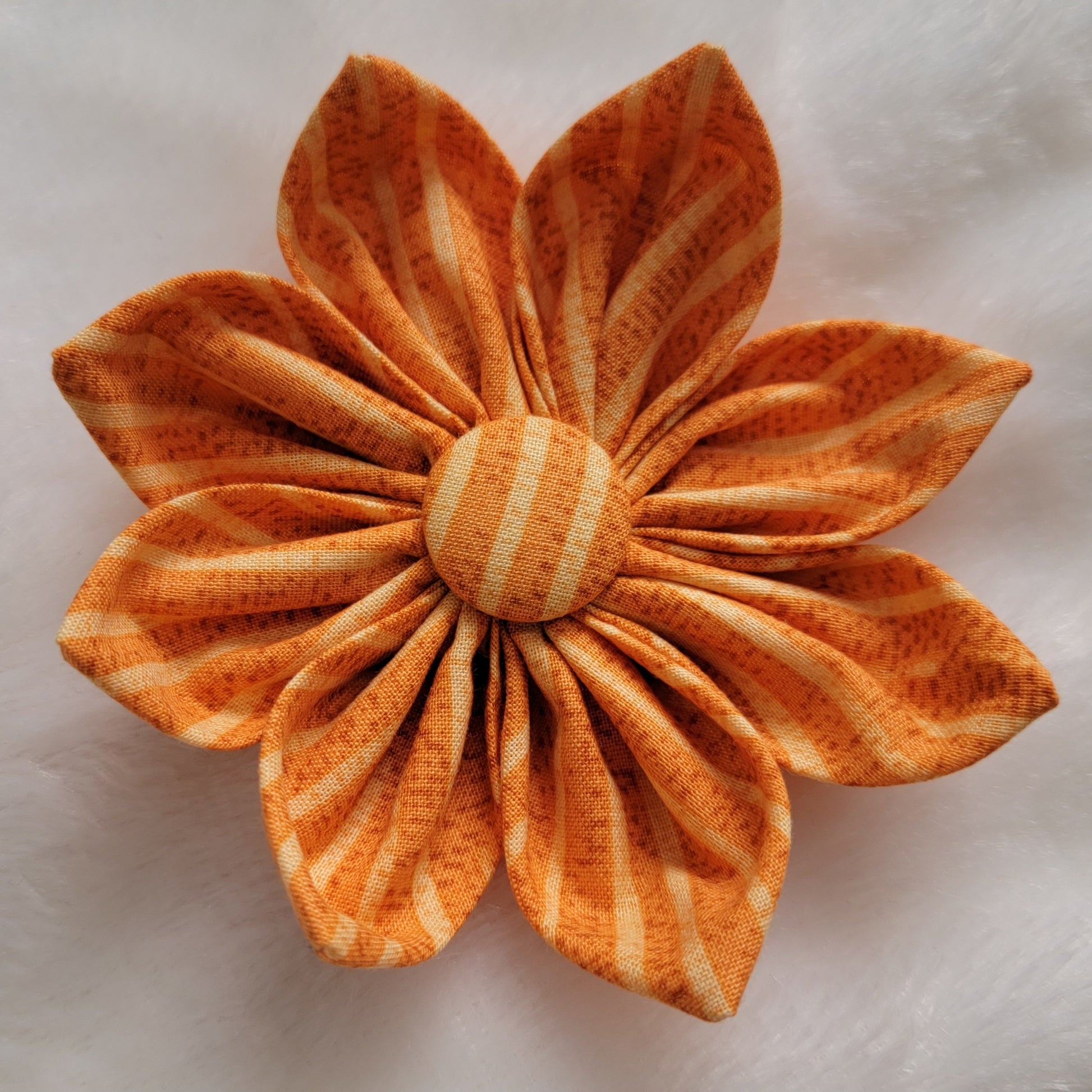 Warm golden tan striped fabric flower.