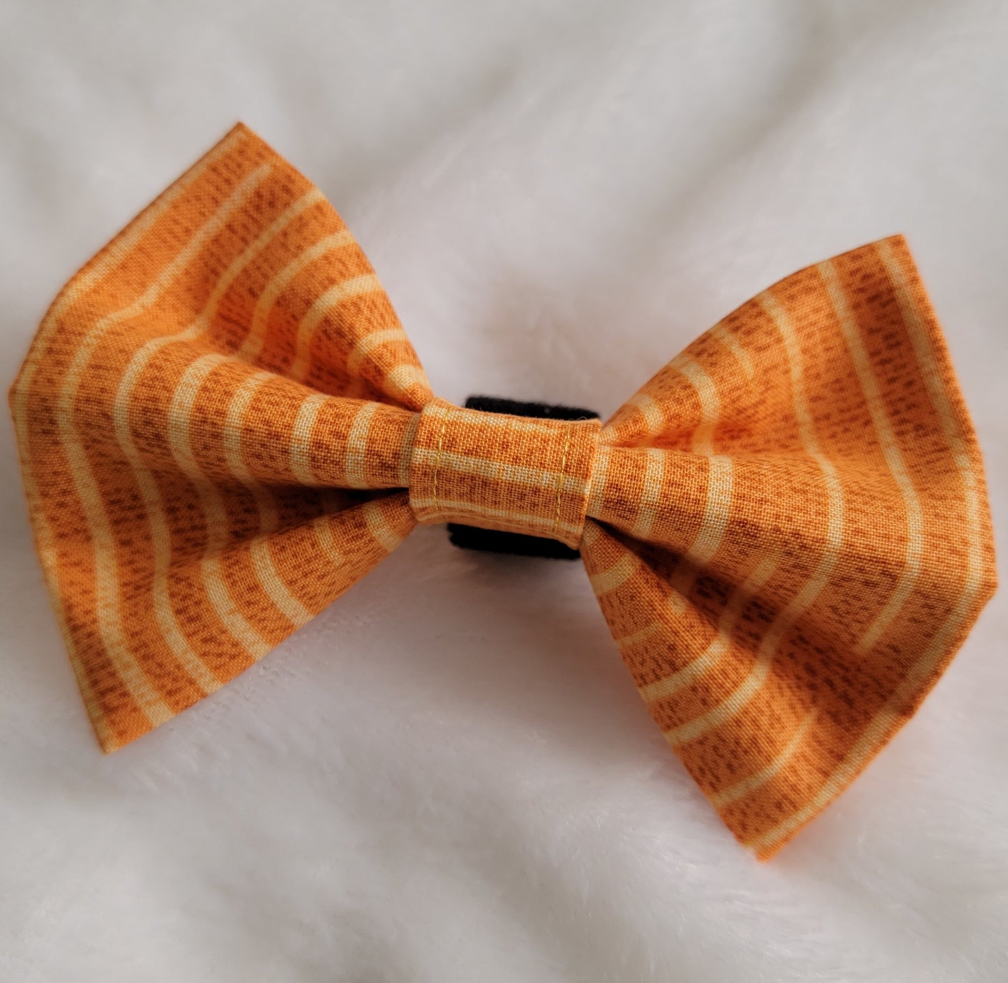 Warm golden tan striped fabric bowtie.