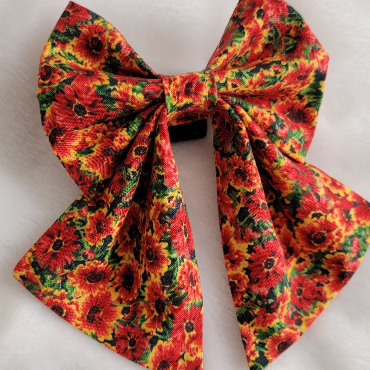 One fabric sailor style bow in bright golden orange marigold print.