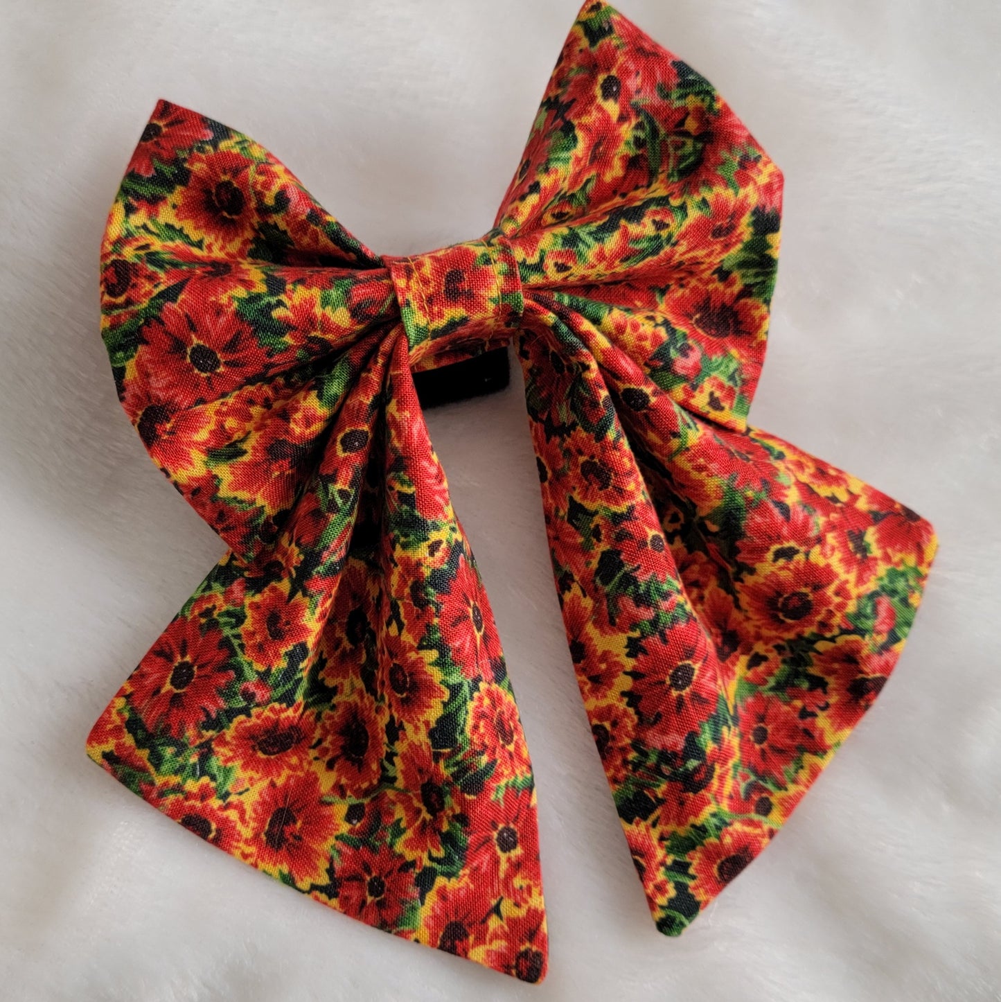 One fabric sailor style bow in bright golden orange marigold print.