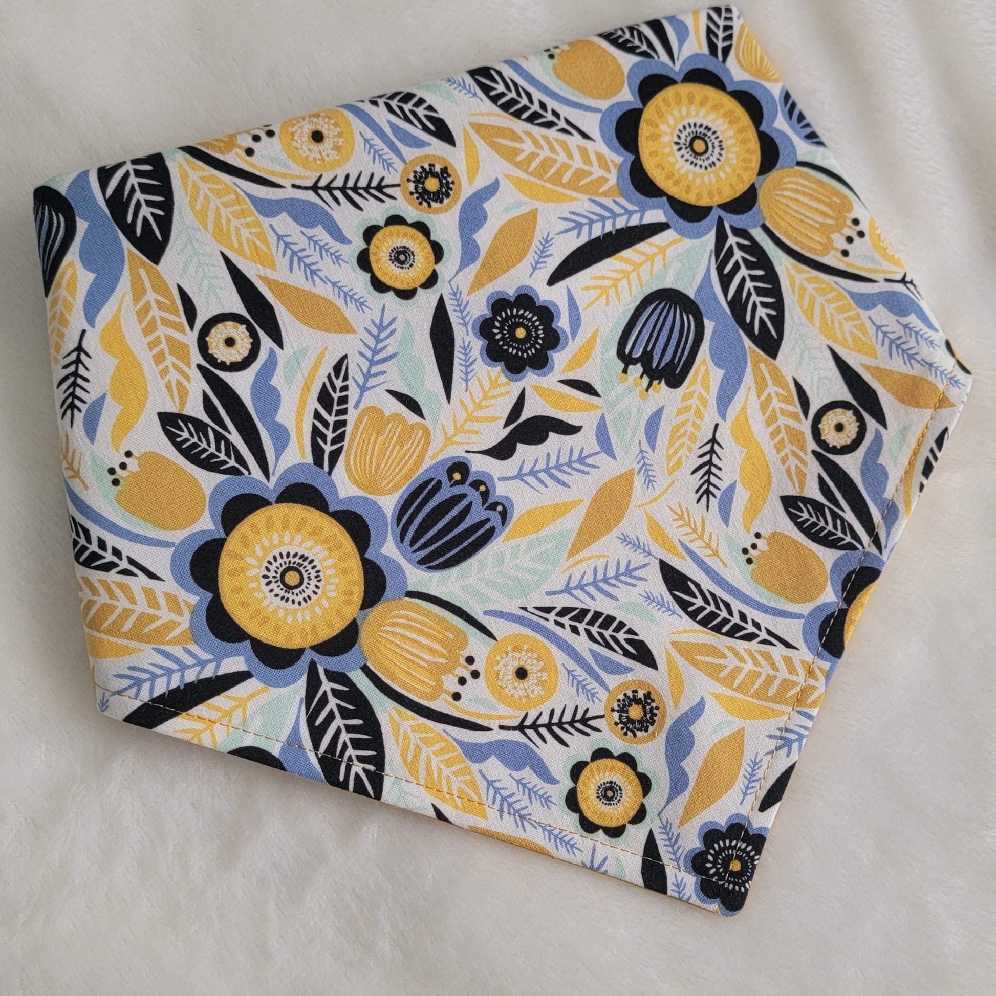 Reversible pet bandana with abstract floral print in navy, blue, aqua and mustard yellow.