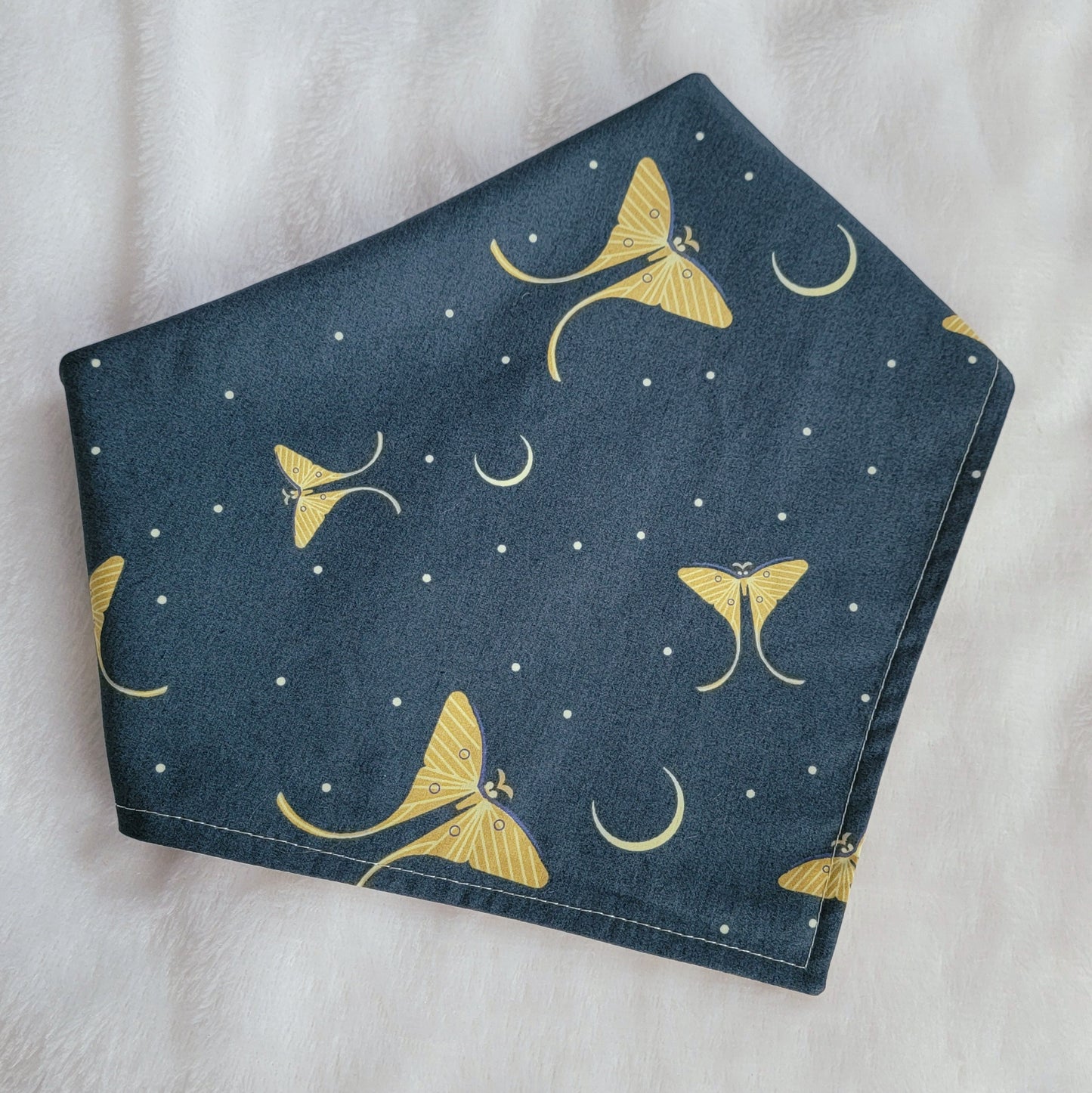 Reversible pet bandana, deep blue-green with moons and Luna moths print in soft light green.