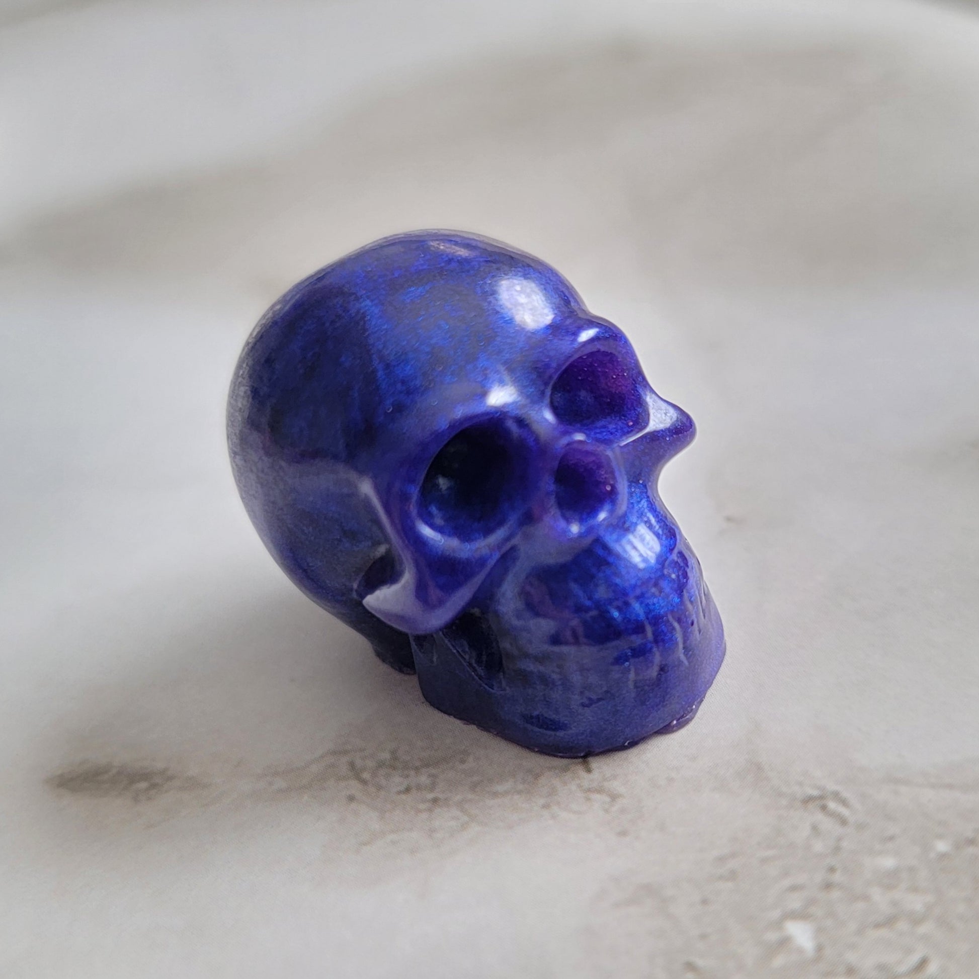 Small shimmering purple epoxy resin skull.