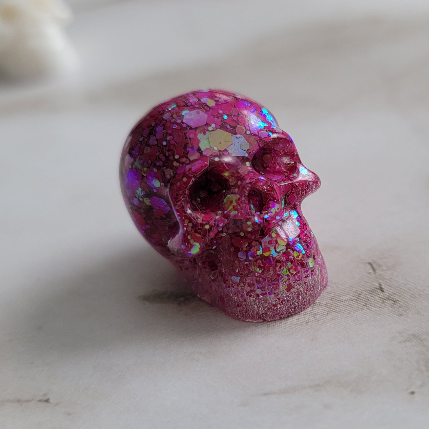 Small pink glitter epoxy resin skull.