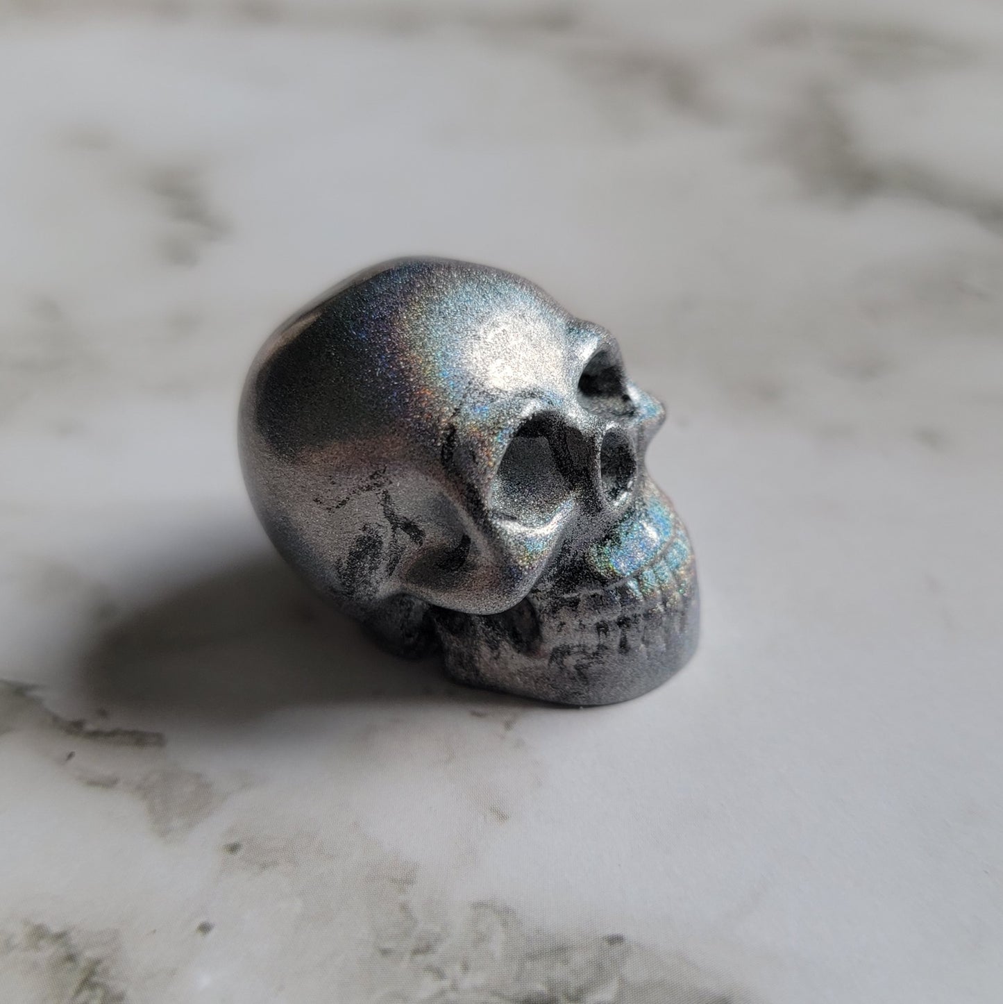 Small silver prism epoxy resin skull.