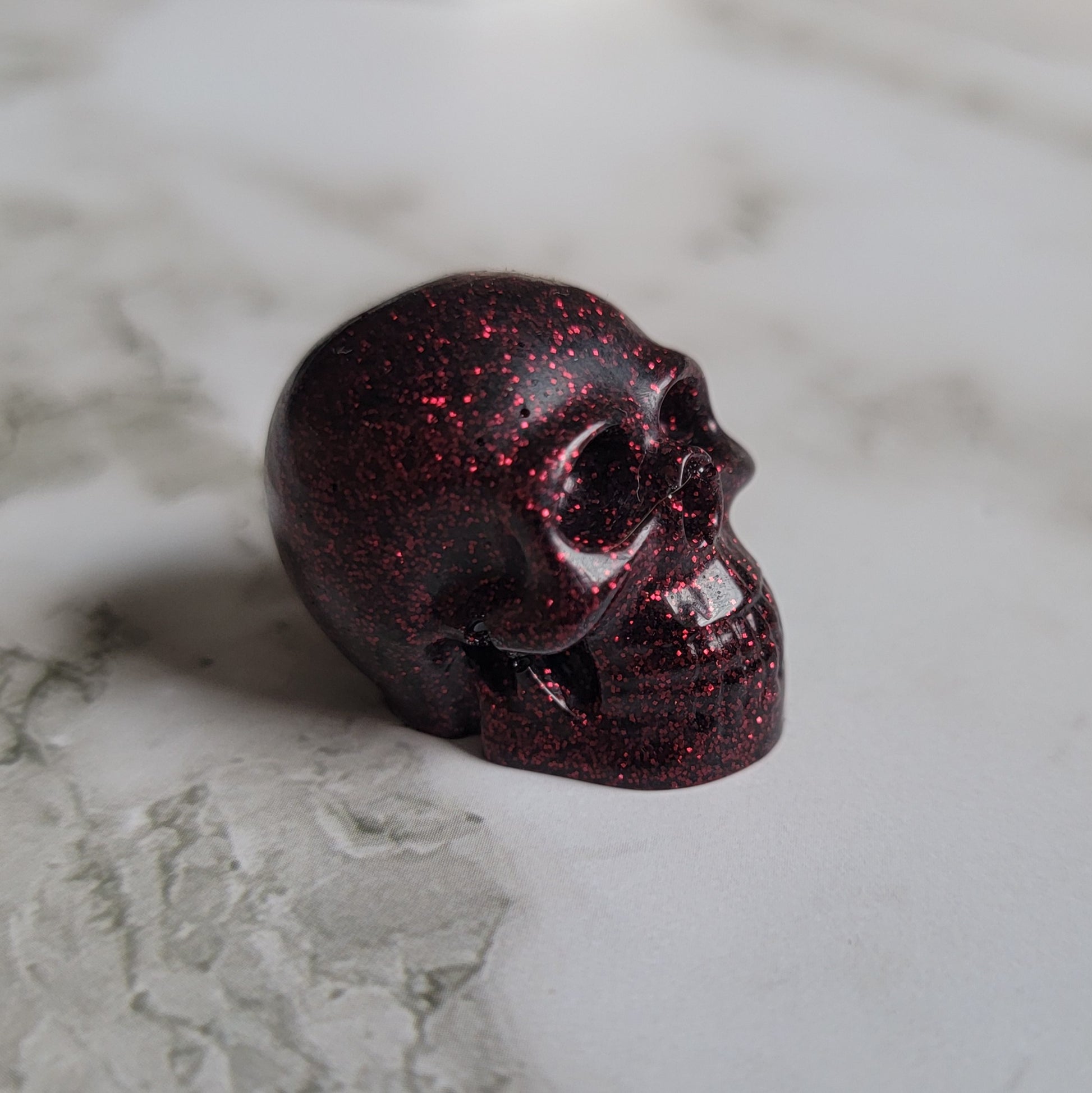 Small dark wine red glitter epoxy resin skull.