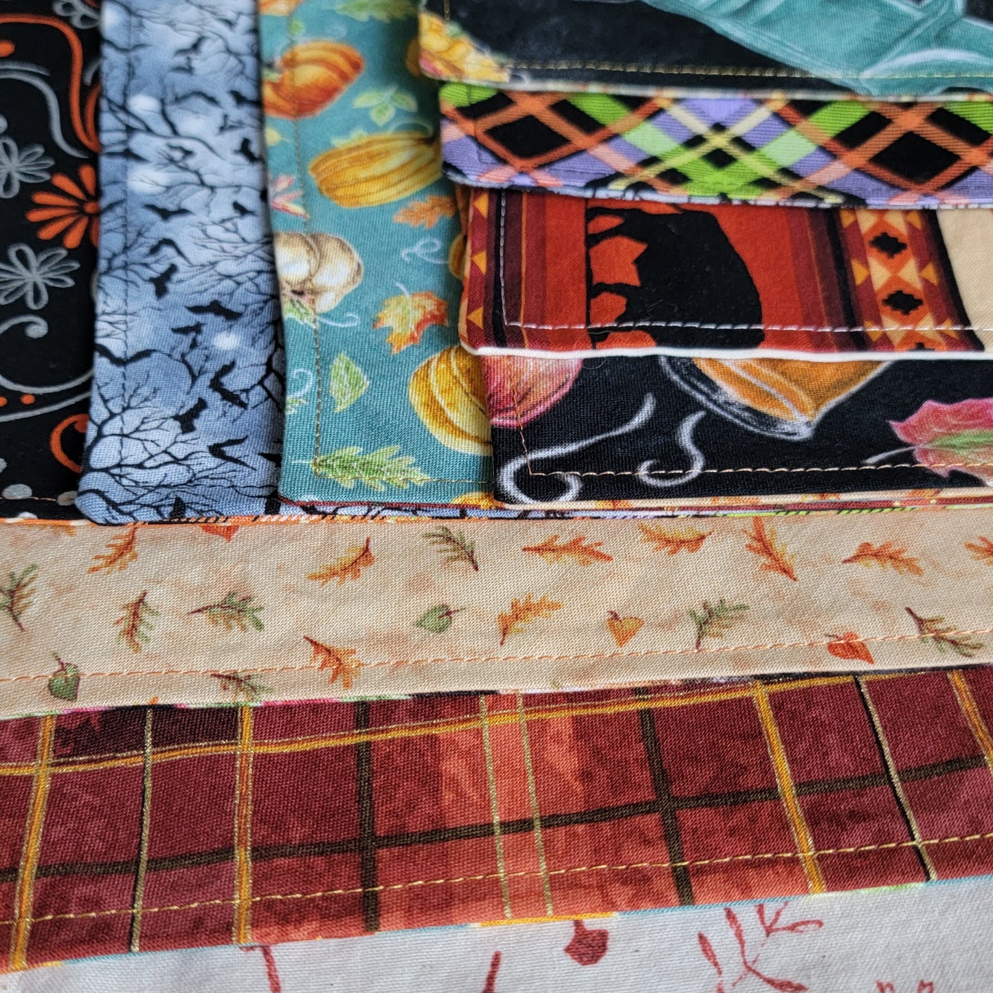 Close up of premade pet bandanas in various fall and Halloween themed prints.