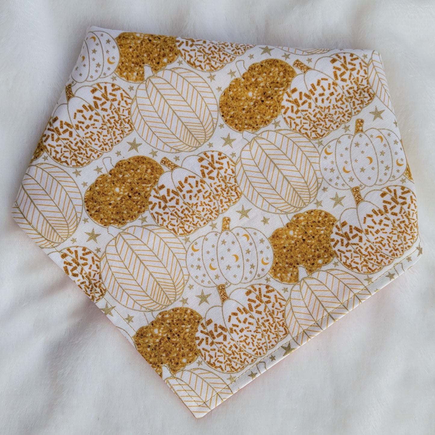 Reversible pet bandana, white with gold pumpkins print shown.