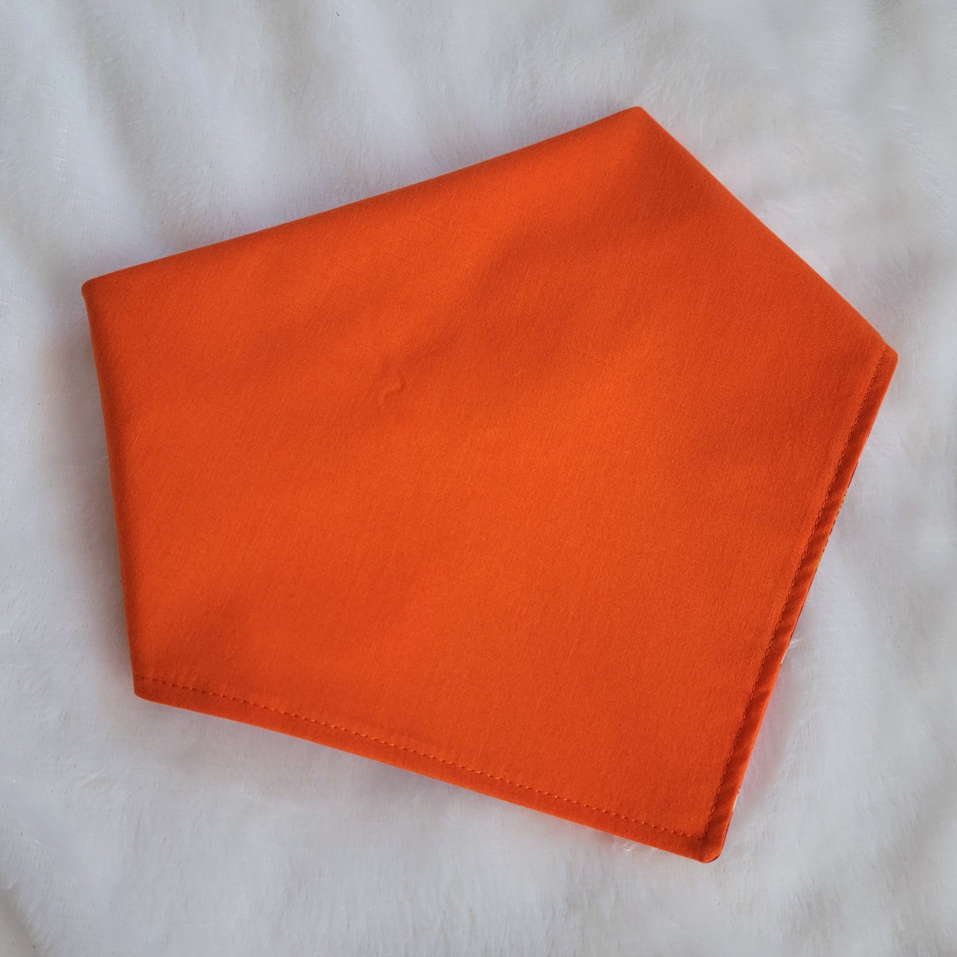 Handmade pet bandana, solid bright orange cotton.