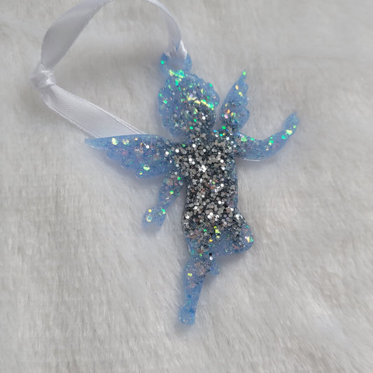 Cherub shaped epoxy resin ornament, made with bright silver and light blue iridescent glitter and a white ribbon attached.