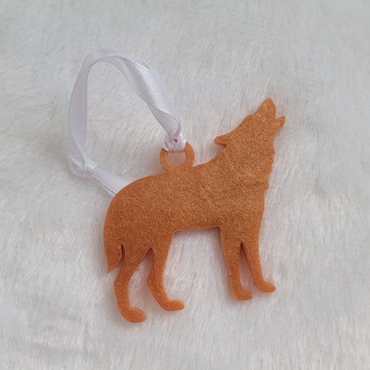 Wolf shaped epoxy resin ornament, made with golden bronze pigment and a white ribbon attached.