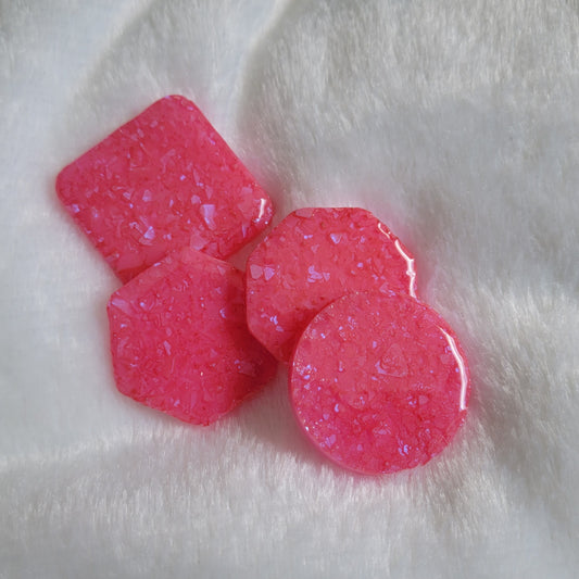 Four bright pink epoxy resin pieces with crystalline texture, one each - square, hexagon, octagon and round.