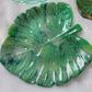 Monstera leaf shaped decorative dish made from epoxy resin, marbled shades of green.