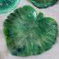 Monstera leaf shaped decorative dish made from epoxy resin, marbled shades of green.
