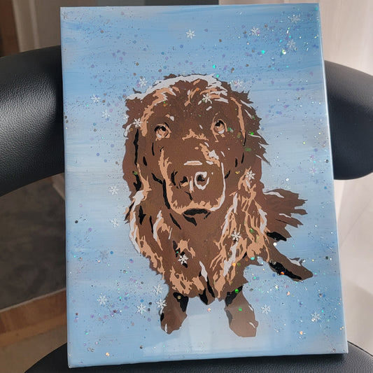 Vinyl art of a brown newfoundland dog on a canvas painted with light blue acrylic paint, adorned with snow glitter and sealed in epoxy resin.