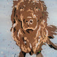 Vinyl art of a brown newfoundland dog on a canvas painted with light blue acrylic paint, adorned with snow glitter and sealed in epoxy resin.