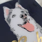 Portrait of a grey and white husky dog made with vinyl on a navy blue canvas background, sealed in epoxy resin with chrome gold vinyl name across the front.