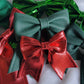 Array of red and green faux leather sailor bows, displayed on a white background.