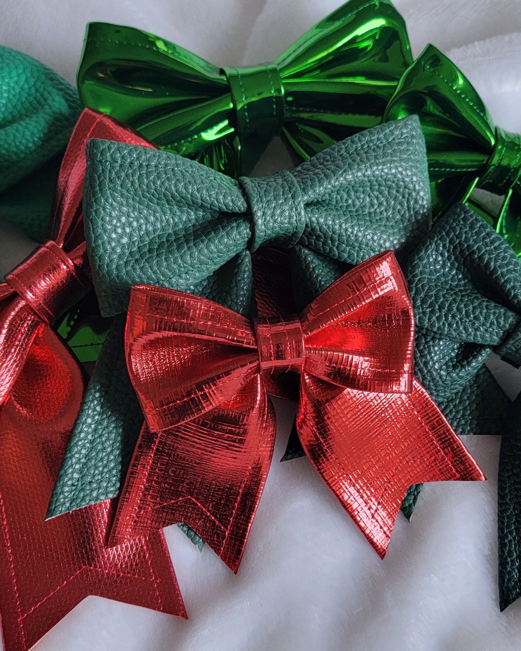 Array of red and green faux leather sailor bows, displayed on a white background.