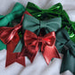 Array of red and green faux leather sailor bows, displayed on a white background.