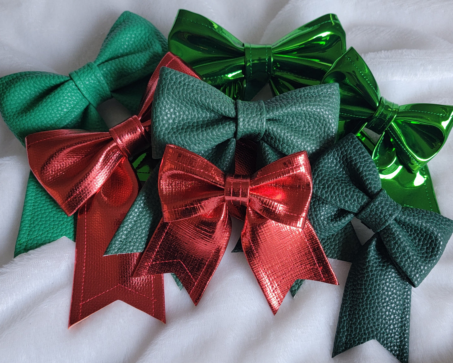 Array of red and green faux leather sailor bows, displayed on a white background.