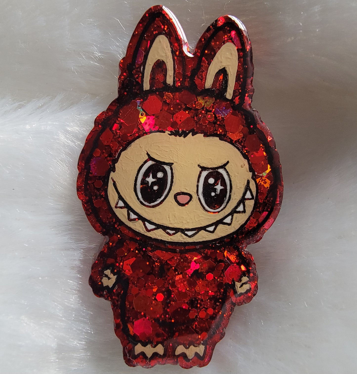 Labubu inspired epoxy resin pet tag, made with red glitter and acrylic painted details.