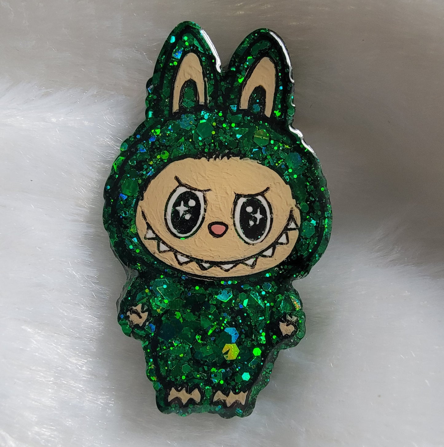 Labubu inspired epoxy resin pet tag, made with green glitter and acrylic painted details.