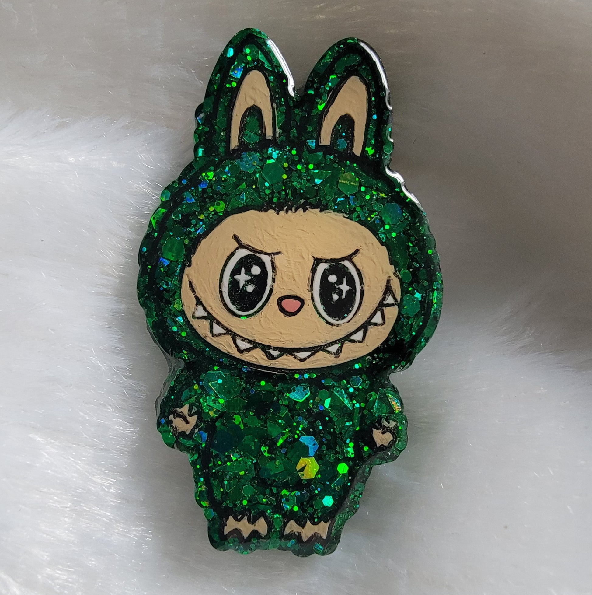 Labubu inspired epoxy resin pet tag, made with green glitter and acrylic painted details.