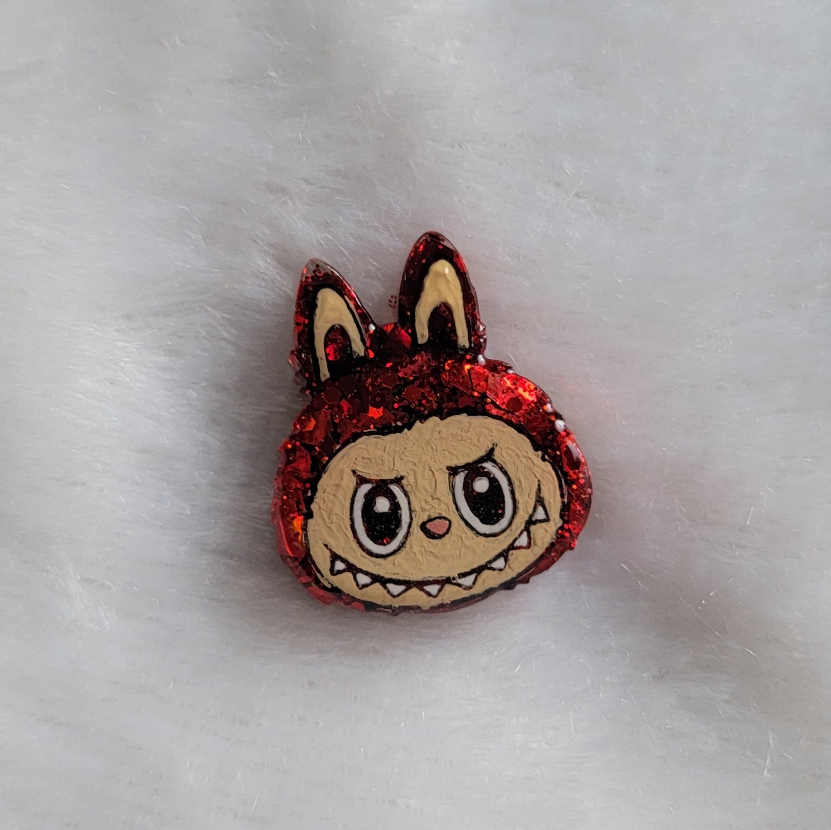 Labubu inspired small epoxy resin pet tag, made with red glitter and acrylic painted details.