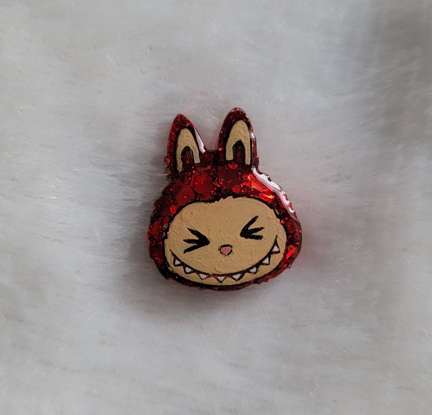 Labubu inspired small epoxy resin pet tag, made with red glitter and acrylic painted details.