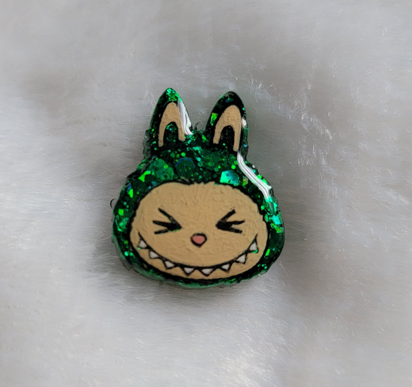 Labubu inspired small epoxy resin pet tag, made with green glitter and acrylic painted details.