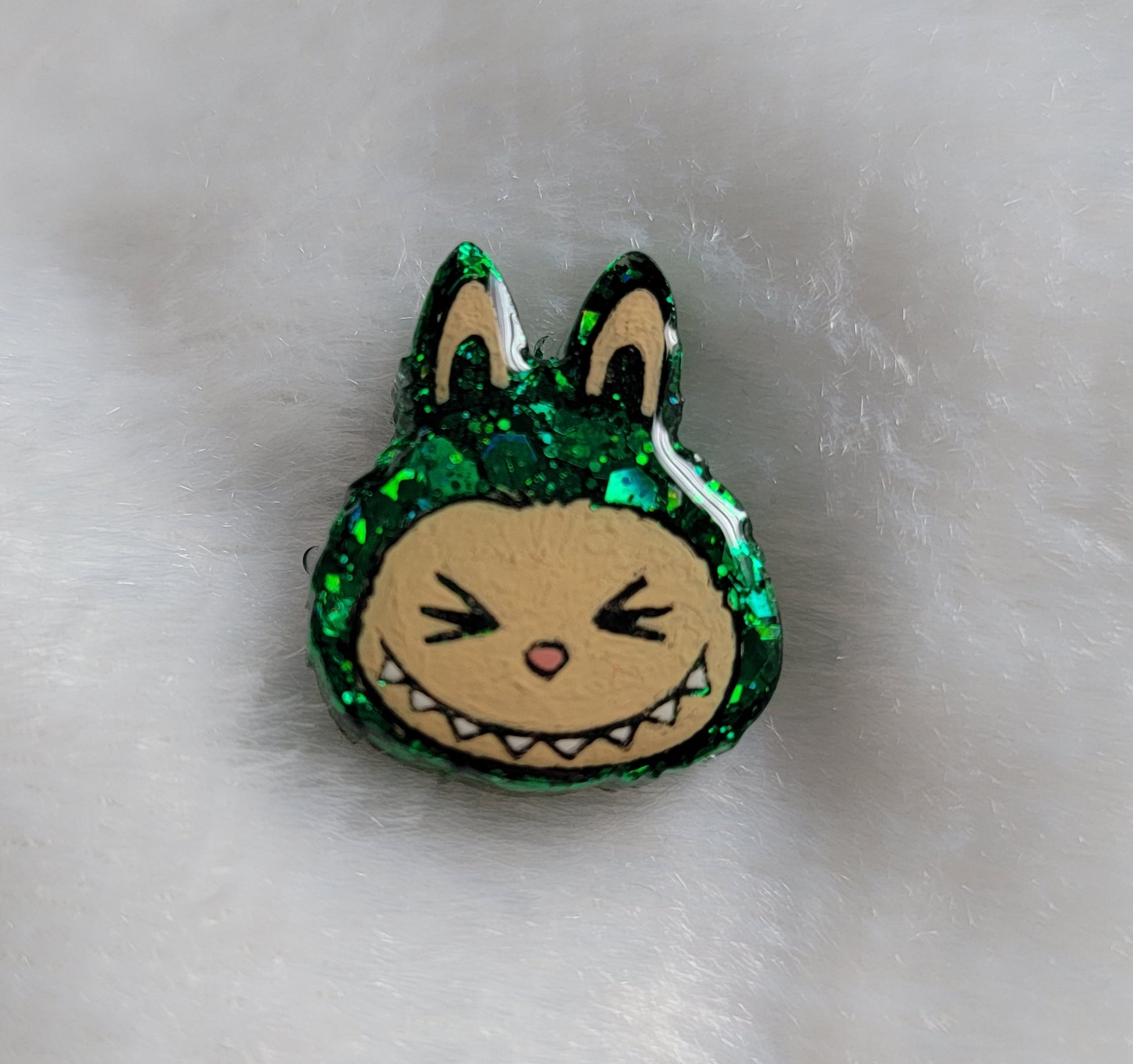 Labubu inspired small epoxy resin pet tag, made with green glitter and acrylic painted details.