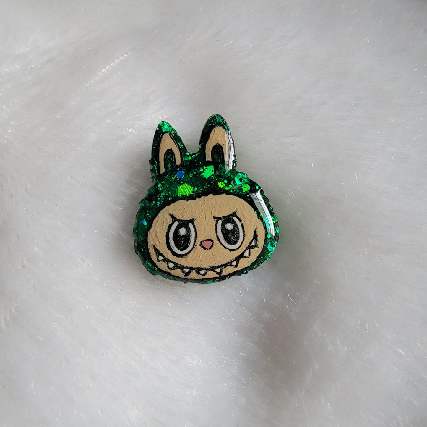 Labubu inspired small epoxy resin pet tag, made with green glitter and acrylic painted details.