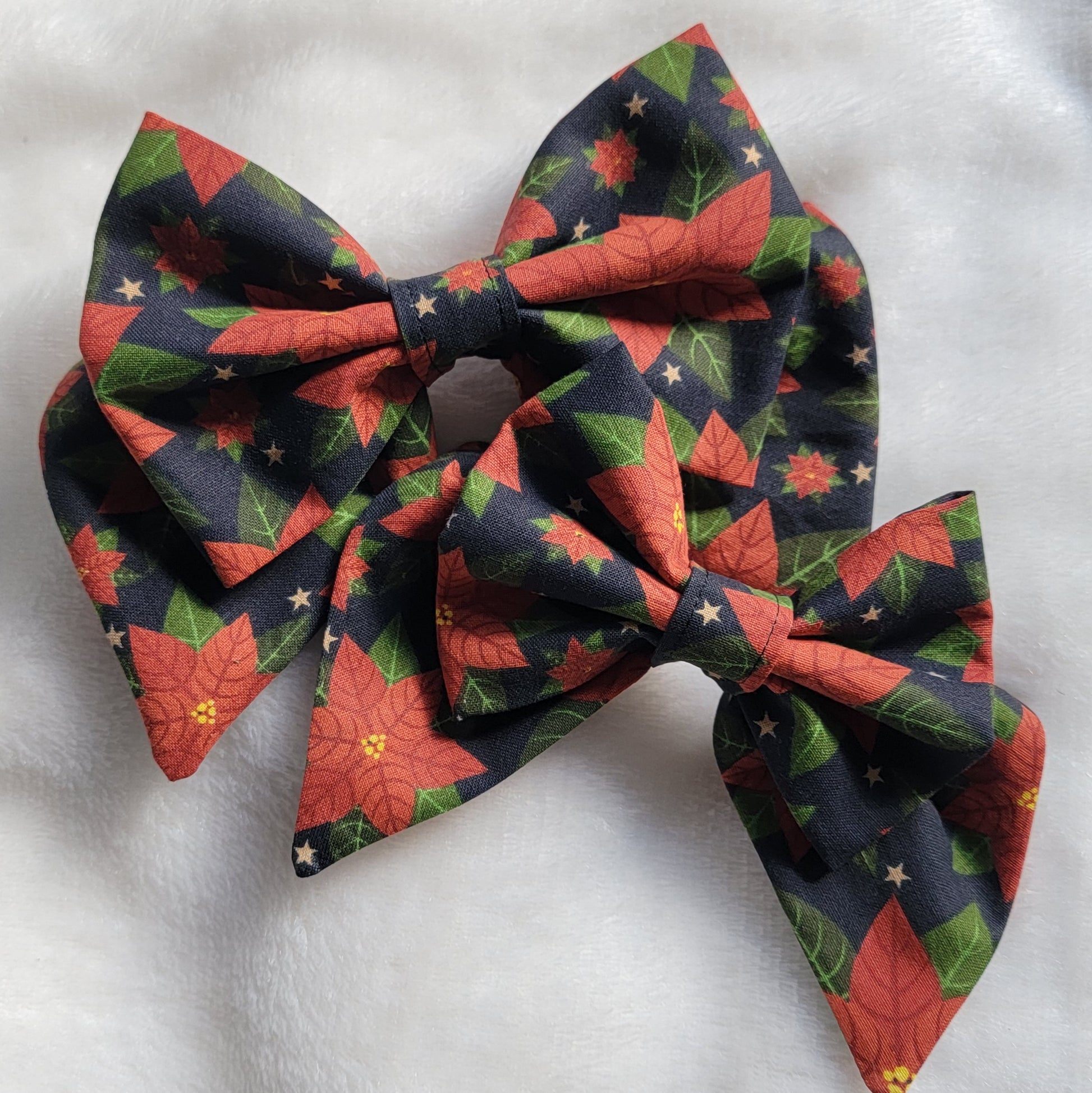 Two sailor bows made with poinsettia print cotton, displayed on a white background.