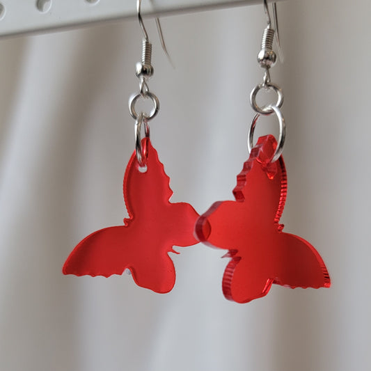 Small drop earrings made from red translucent butterfly shaped epoxy resin pieces.