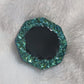 Octagon shaped epoxy resin piece with green crystal texture border and black center, displayed on a white background.