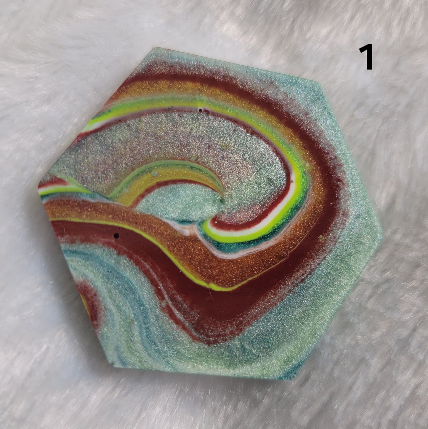Hexagon shaped epoxy resin piece with swirling greens and rust colored pigments, displayed on a white background. The number "1" is in the top right corner.