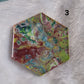 Hexagon shaped epoxy resin piece with swirling greens and rust colored pigments, displayed on a white background. The number "3" is in the top right corner.