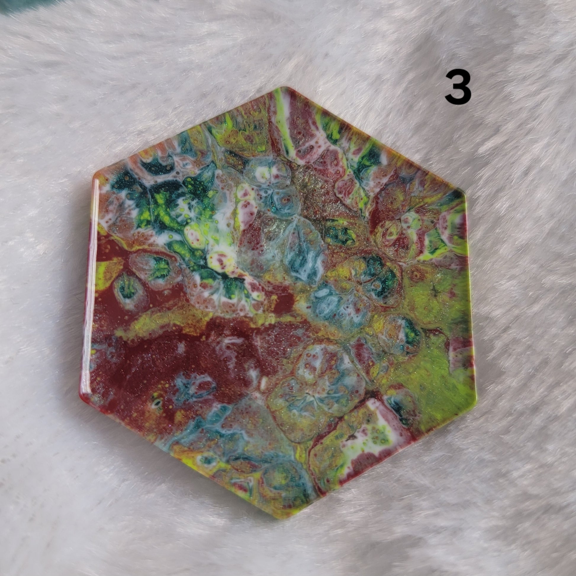 Hexagon shaped epoxy resin piece with swirling greens and rust colored pigments, displayed on a white background. The number "3" is in the top right corner.