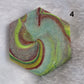 Hexagon shaped epoxy resin piece with swirling greens and rust colored pigments, displayed on a white background. The number "4" is in the top right corner.