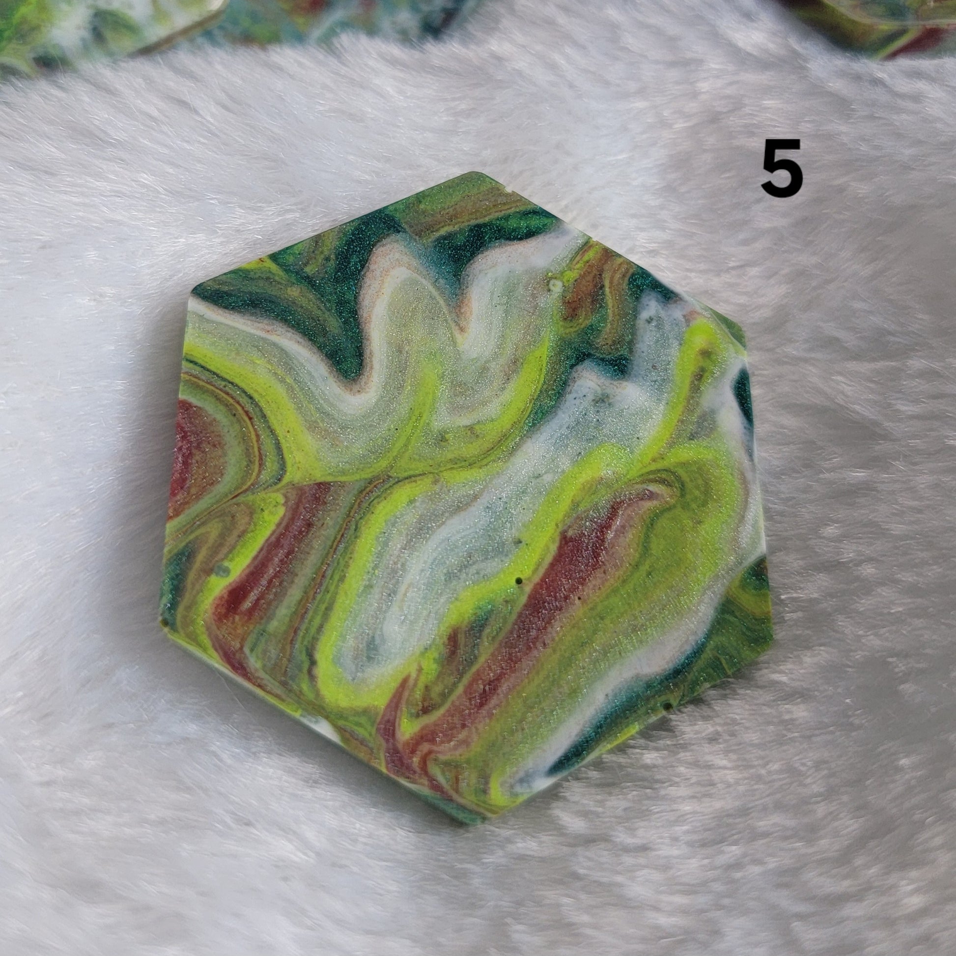 Hexagon shaped epoxy resin piece with swirling greens and rust colored pigments, displayed on a white background. The number "5" is in the top right corner.