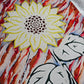 Close up of sunflower art made with yellow, green and brown vinyl, with rust and navy blue acrylic abstract painted background on white; accented with gold glitter and sealed in epoxy resin.