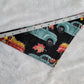 Bandana shown with measuring tape to show size is 14.5", print has trucks with pumpkins in them on black background.