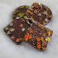 Four epoxy resin pieces, two square two round, with dark brown glitter and fall leaf shaped glitter.