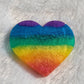 Heart shaped epoxy resin piece with horizontal rainbow stripes in shimmering mica pigments.